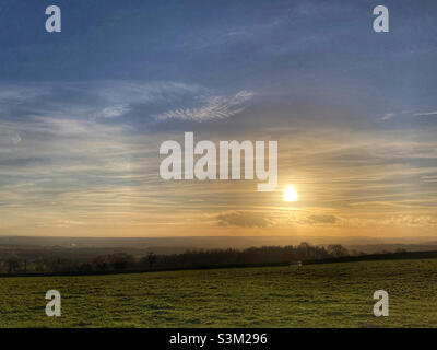 Sun setting over fields in Guiseley West Yorkshire Stock Photo