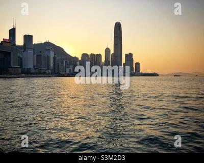 2ifc (2 International Finance Centre), a skyscraper in Central and Hong Kong's second tallest building, the Hong Kong Island skyline and Victoria Harbour, at sunset Stock Photo