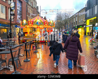 Christmas shoppers in abroad street in a reading, UK a few weeks before Christmas. Stock Photo