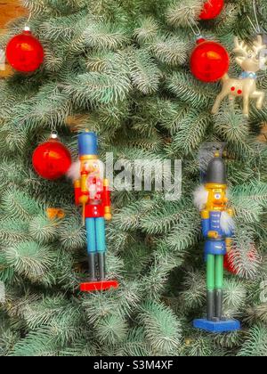 A small apartment patio, in Utah, USA, during the holiday season has a Christmas tree decorated with red ornaments and nutcrackers. Stock Photo