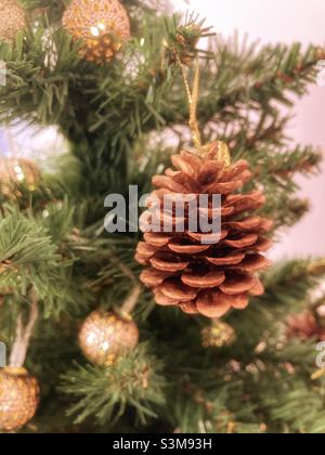 A fir cone hanging on a Christmas tree. Stock Photo
