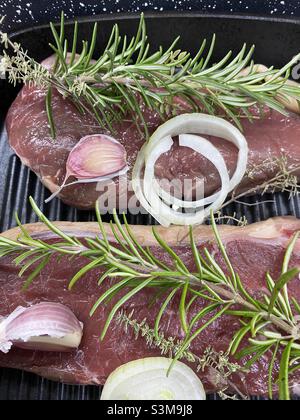 Christmas Steak Dinner with rosemary garlic and onions Stock Photo