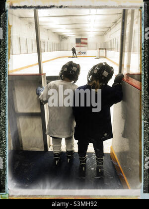 Best friends and teammates ice hockey players waiting to get into the ice ring for their practice Stock Photo