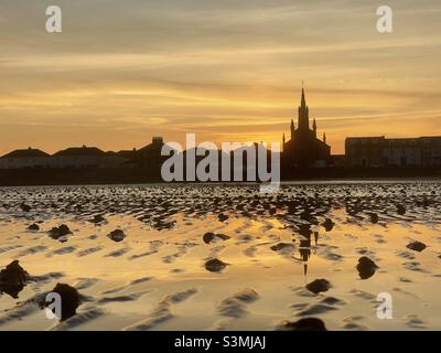 Sunset reflection on wet sand Stock Photo