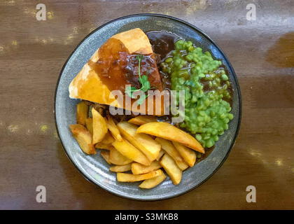 Meat pie chips and mushy peas Stock Photo