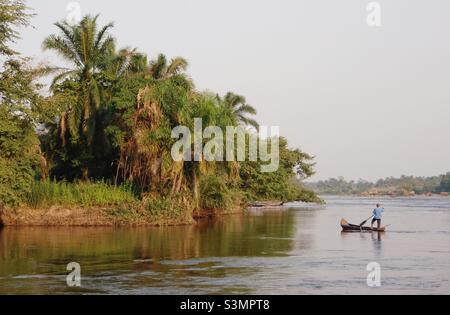 Man in a canoe on the Congo river Stock Photo