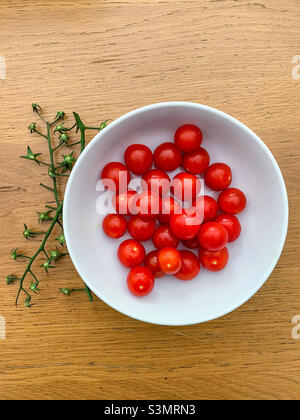 Bowl of red Cherry tomatoes with vine removed Stock Photo