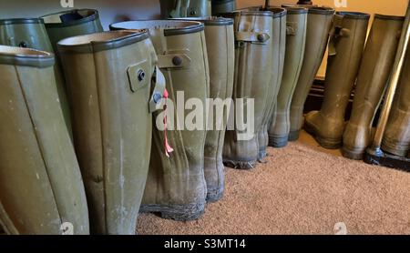 Different sized Wellington boots ready for guests in a country hotel Stock Photo
