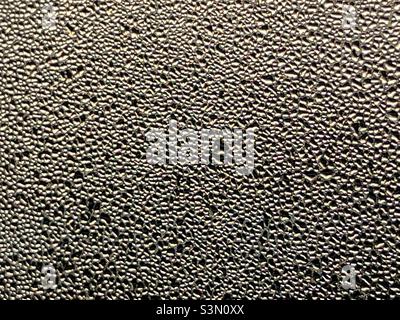 An almost uniform field of small water droplets on a window pane, condensation on a steamed up window Stock Photo
