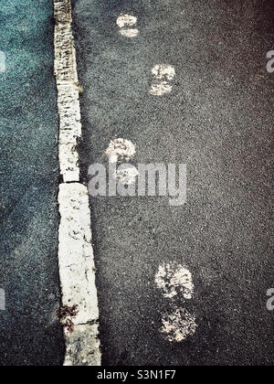 Footprints on a pavement made with paint Stock Photo