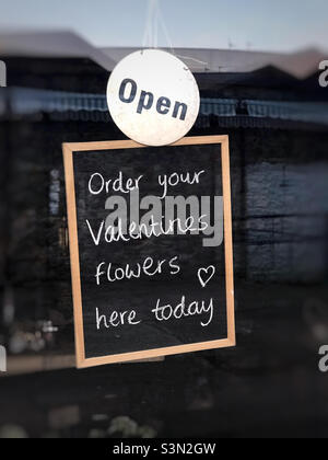 A sign in a flower shop suggesting you can buy your Valentines Day flowers from them. Stock Photo