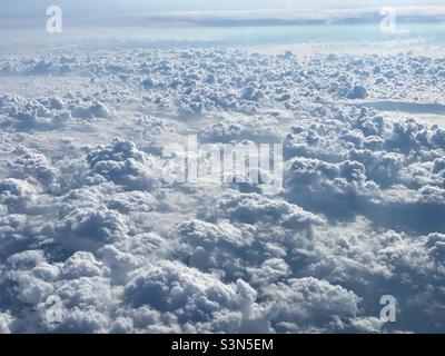 Above the clouds: view from an airplane. Stock Photo