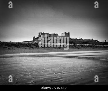 ‘The Castle’ Bamburgh Castle from the beach in classic black & white Stock Photo