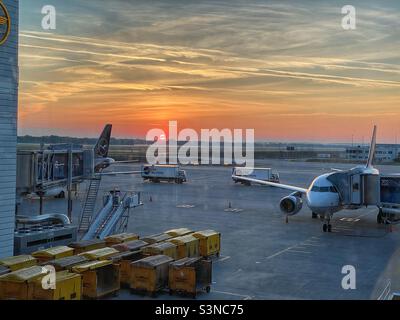 Orange-colored sunrise at Munich Airport, Germany. Stock Photo
