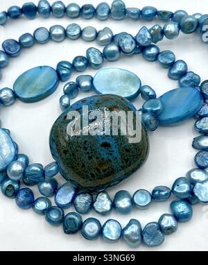 Blue necklace made of freshwater pearls and ceranic eye catcher bead Stock Photo