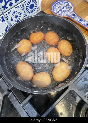 Eggs boiling in water Stock Photo