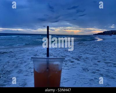 https://l450v.alamy.com/450v/s3nh47/a-drink-on-a-white-sand-beach-at-sunset-bloody-mary-red-drink-cocktail-in-a-clear-plastic-cup-with-a-straw-in-front-of-the-ocean-and-sand-gulf-of-mexico-scenic-beach-evening-relaxing-moments-s3nh47.jpg