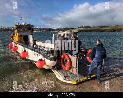 Passengers board the Rock to Padstow ferry boat that crosses the River Camel estuary in Cornwall UK Stock Photo