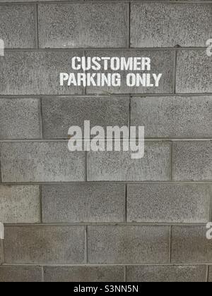 Customer Parking Only painted on wall Stock Photo