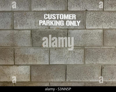 Customer Parking Only painted on wall Stock Photo