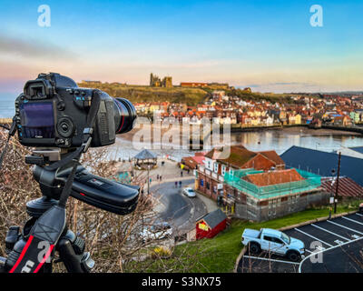 Professional photographer taking photos with canon digital slr camera of Whitby at dusk Stock Photo
