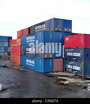 shipping containers stacked up in depot Stock Photo