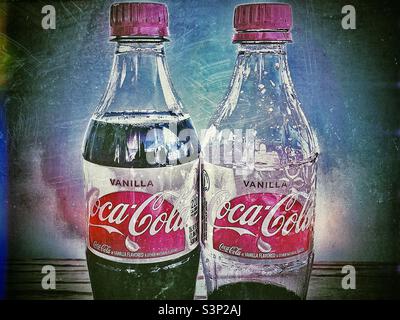 Two bottles of Vanilla Coke, one full and the other nearly empty. Grunge effect done via various IOS apps. Stock Photo