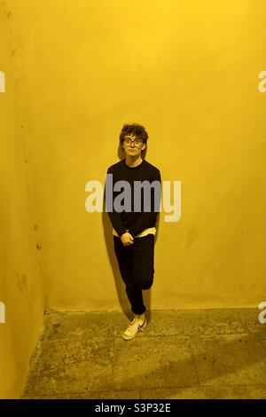 Black on yellow curly haired model. Stock Photo