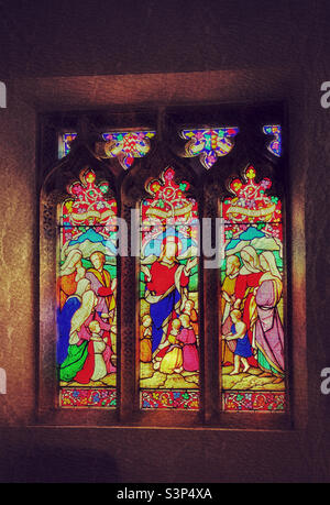 A creative effect image of a stained glass window in a small parish church in the south of England. The glass pictures feature Jesus Christ, the saviour of all Christians. Photo ©️ COLIN HOSKINS. Stock Photo