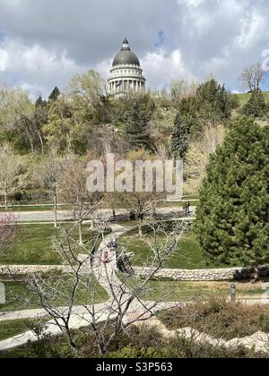 A view looking out over Memory Grove Memorial Park in Salt Lake City, Utah, USA on a spring day. You can make out a few people milling about on the grounds and the State Capitol in the background. Stock Photo