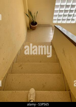 Going down the stairs with the first rays of sun in Havana, Cuba. Urban decay. Dirty stairs. Stock Photo