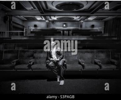 Portrait of a Black male in a disused auditorium. Stock Photo