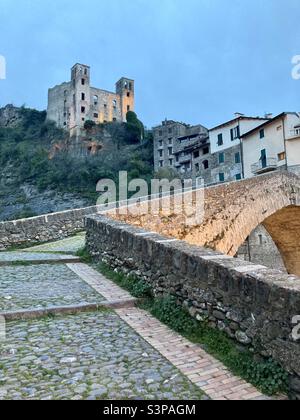 Approaching the Ponte Vecchio with the Castle of the Doria and the old town of Dolceacqua in the background. Stock Photo