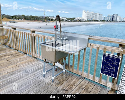 Fish cleaning station on the Springmaid Pier in Myrtle Beach SC. Stock Photo