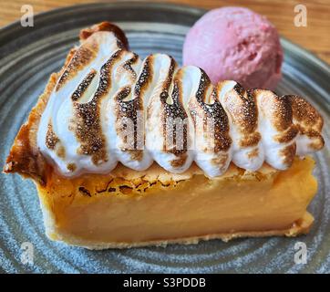 ‘The perfect ending’ lemon meringue pie served with raspberry ice cream. Always room for dessert Stock Photo