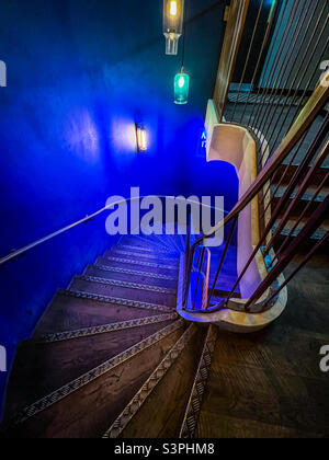 Old wooden staircase with blue led lights Stock Photo