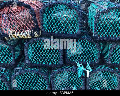 Lobster pots piled up at the harbour Stock Photo