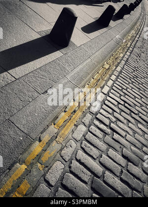 Cobblestones and double yellow lines abstract Stock Photo