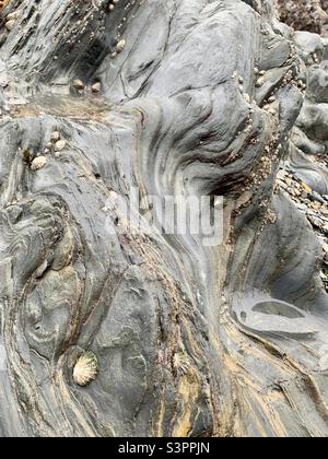 Interesting formations in rocks on the beach Stock Photo