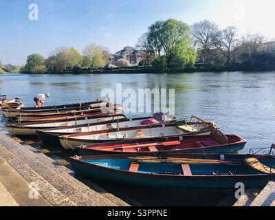 Man arranging boats on river Thames in Richmond london