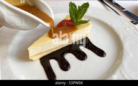 Cheesecake is a sweet dessert consisting of several layers. The main layer consists of a mixture of soft fresh cheese, eggs and sugar. The bottom layer consists of crushed cookies Stock Photo