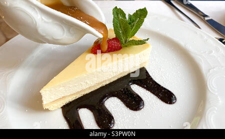 Cheesecake is a sweet dessert consisting of several layers.  The main layer consists of a mixture of soft fresh cheese, eggs and sugar.  The bottom layer consists of crushed cookies Stock Photo