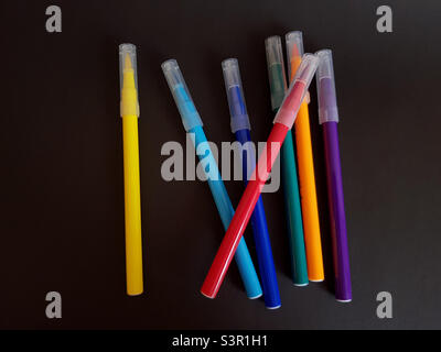 Multi-colored markers for drawing. Markers on a black isolated background Stock Photo