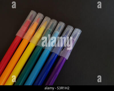 Multi-colored markers for drawing.  Markers on a black isolated background Stock Photo