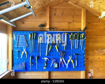 Rack for tools on the wall of a garden shed Stock Photo