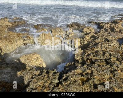 Rock pool filling as the waves subside in Cozumel Mexico Stock Photo