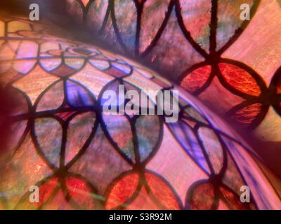 Colorful abstract pattern created with prism in front of camera lens. Overlapping image detail of stained glass window with curves Stock Photo