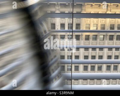 Abstract pattern created with prism in front of camera lens. Facade of a historic building seen through window with partial distortion. Focus on Venetian blinds Stock Photo