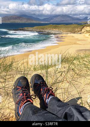 Sitting in the sand dunes at Traigh Mhor Borve, Sandy beach on the Isle of Harris, Scotland Stock Photo