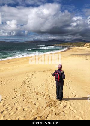 Hiker on Traigh Mhor at Borve, Sandy beach on the Isle of Harris, Scotland Stock Photo